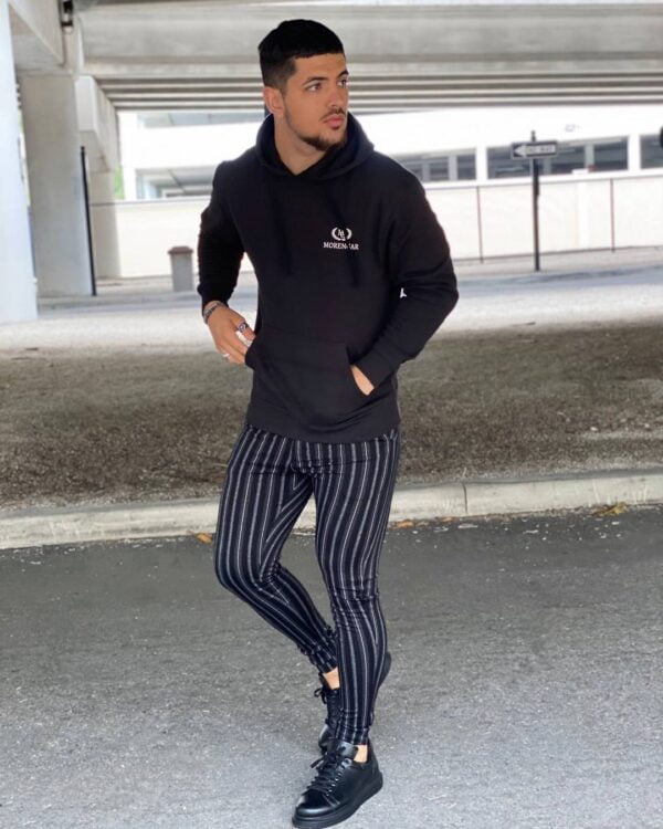 A black hoodie with black pinstripe pants.