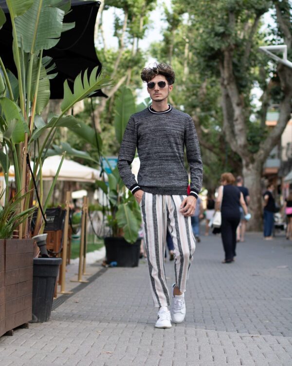 A sweater with pinstripe pants.