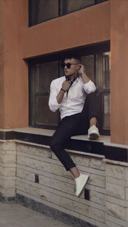 A white button-down shirt with black pinstripe pants.