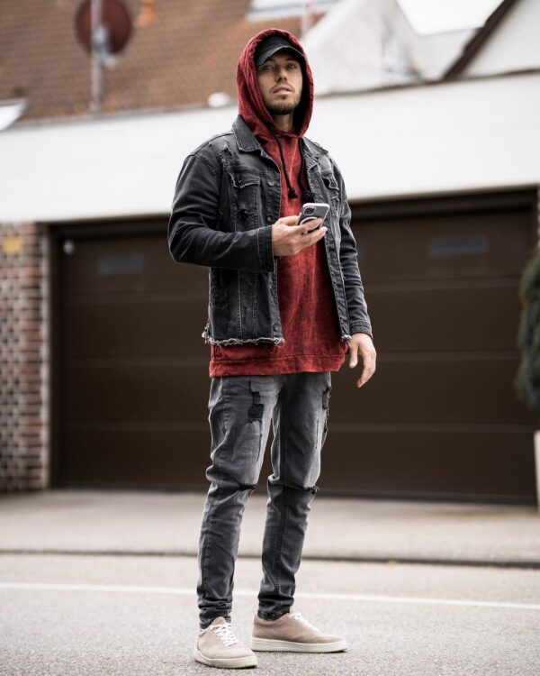 A red hoodie with a gray denim-on-denim look.
